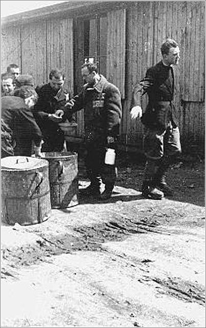 Prisoners receive meager food allocations at the Plaszow camp. Krakow, Poland